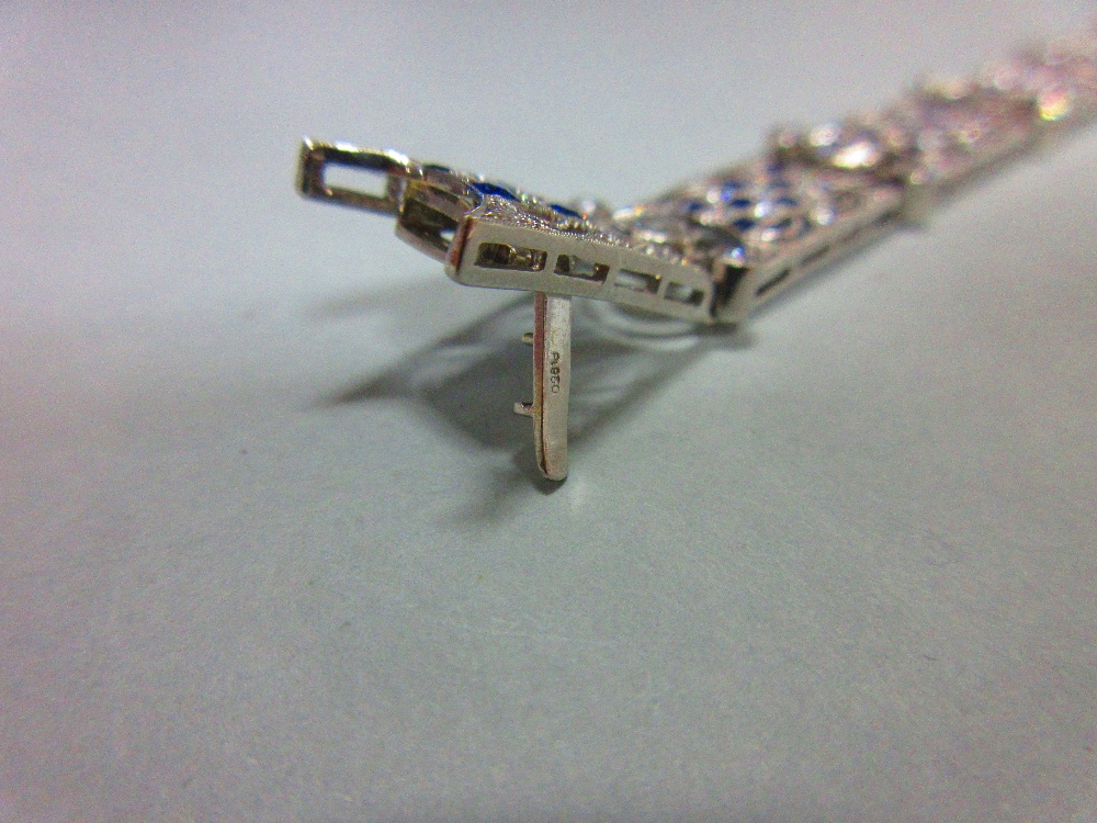 An art deco diamond and sapphire bracelet, designed as nine geometric pierced panels with a - Image 6 of 8