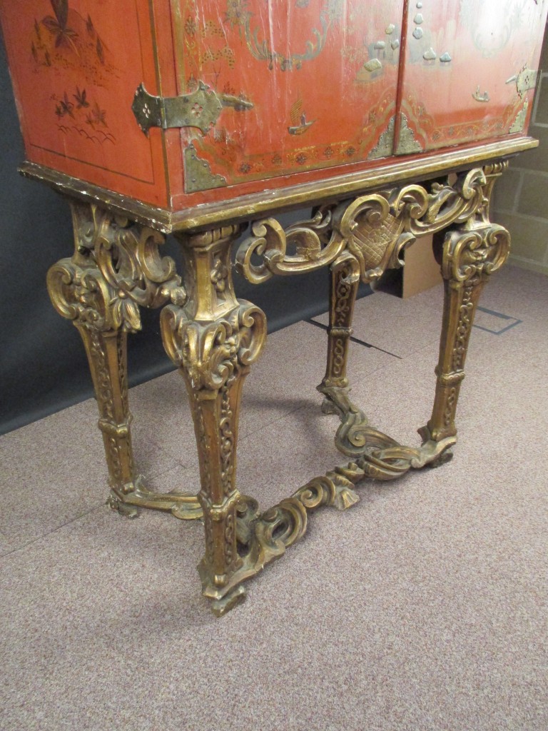 An 18th century Chinese red lacquer cabinet on a giltwood stand, decorated with a traditional - Image 3 of 9