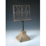 A 19th century wrought iron table lectern, the rectangular stand with applied s-scrolls and