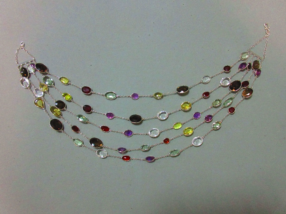 A five strand multi gemset necklace, composed of oval cut hessonite garnets, prasiolites, amethysts,