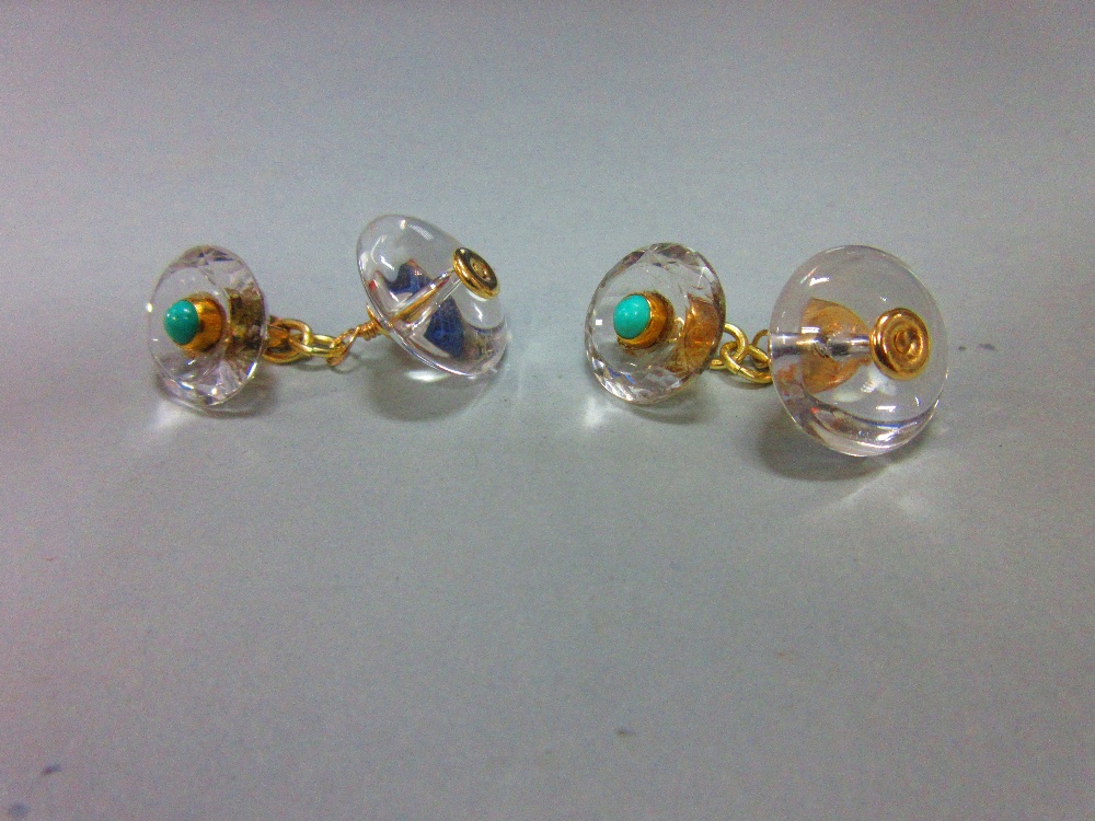 A pair of rock crystal and turquoise cufflinks, each with a circular cabochon turquoise collet set