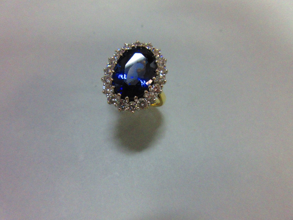 A large sapphire and diamond cluster ring, the oval cut deep blue sapphire, estimated weight 9. - Image 6 of 6