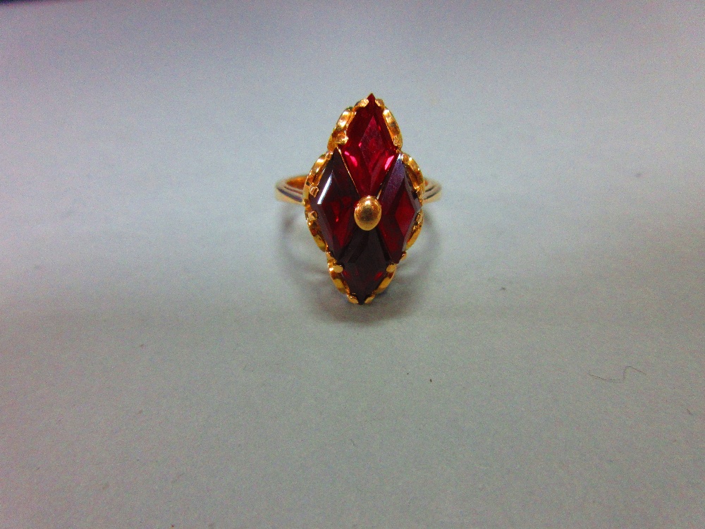 A modern red hardstone ring, the four diaper step cut deep crimson red stones, believed to be