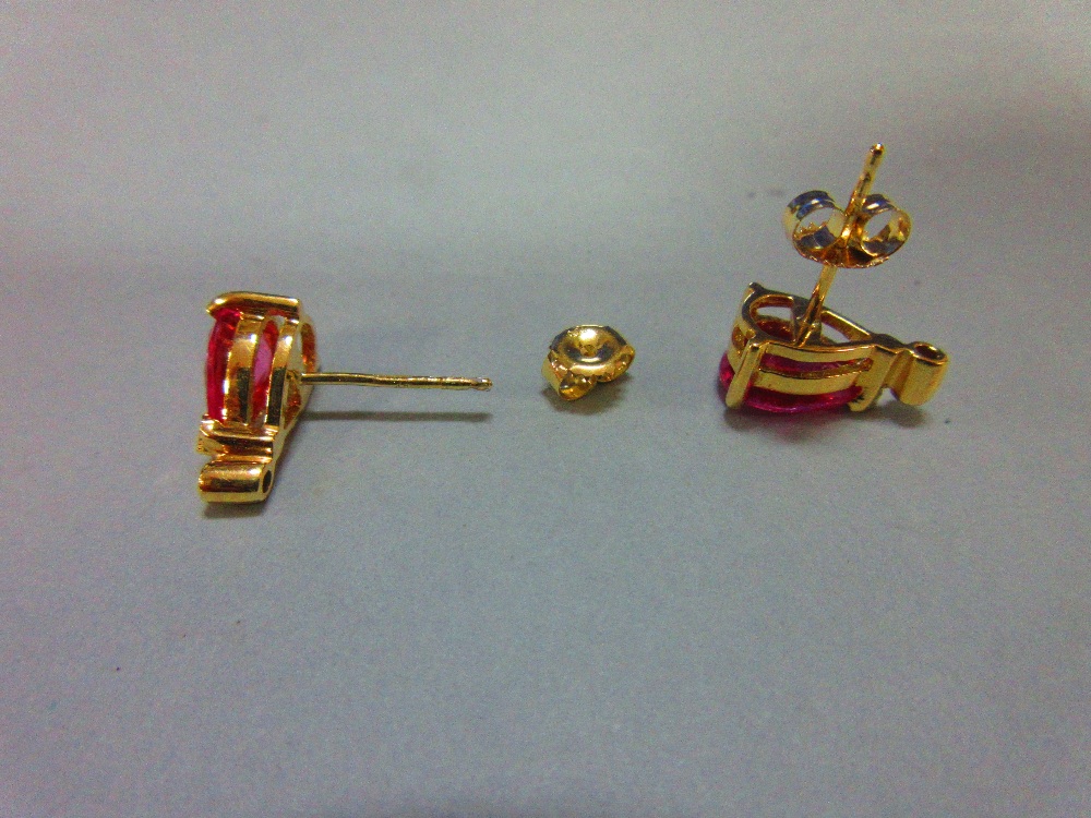A pair of pink sapphire, diamond and 18ct gold earstuds, each post headed by a three claw set pear - Image 2 of 5