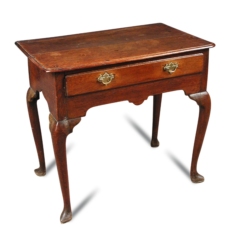 A Queen Anne oak lowboy, fitted one drawer, brass plate handles, fret carved frieze with central