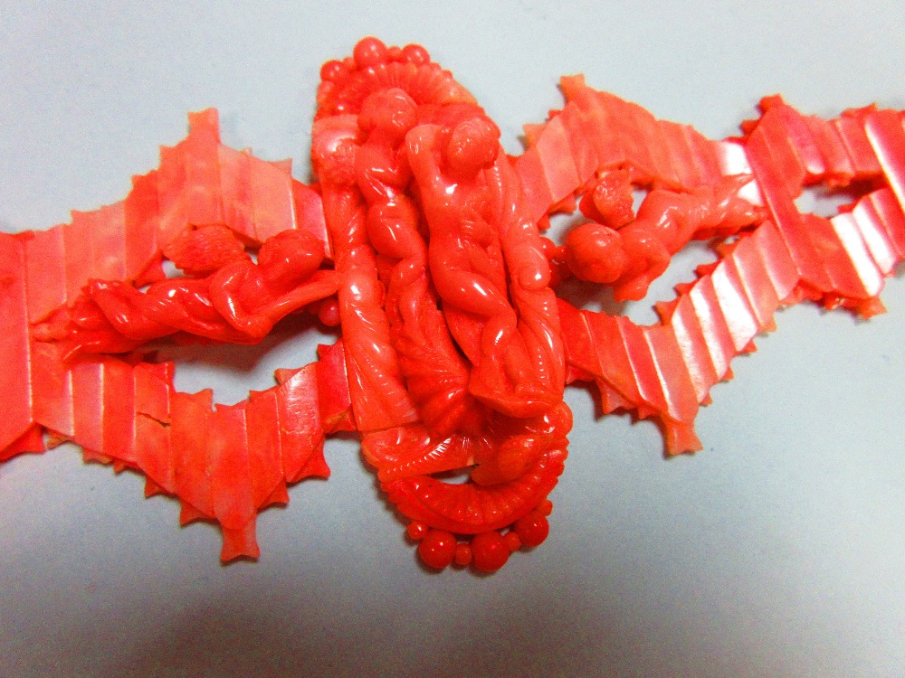 An Italian carved coral choker, designed with a central long oval feature with a fully modelled