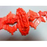 An Italian carved coral choker, designed with a central long oval feature with a fully modelled