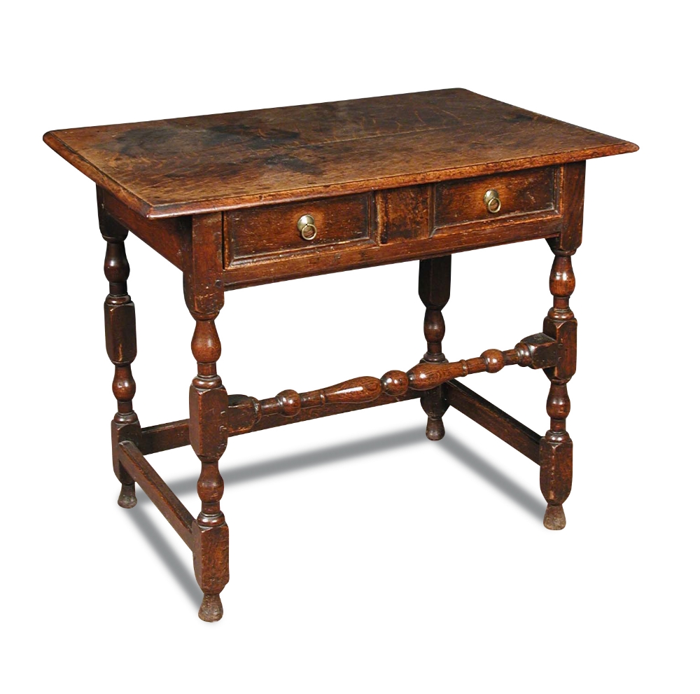 A late 17th century oak side table, fitted a single drawer with panel moulded front, brass ring