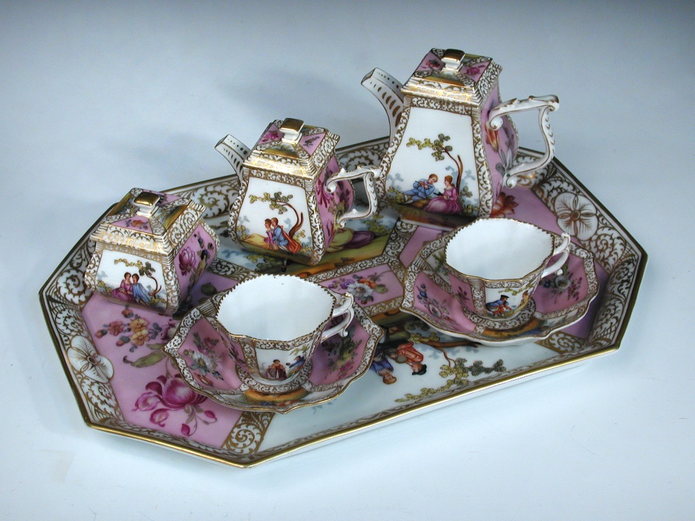 An early 20th century Crown Dresden tete a tete, each piece painted with pairs of figures in