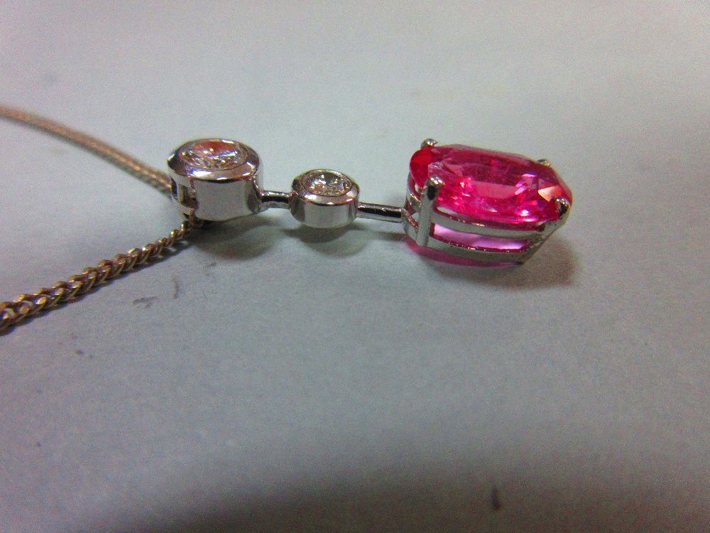 A pink sapphire and diamond pendant set in 18ct white gold, designed as a line of three stones - Image 4 of 6