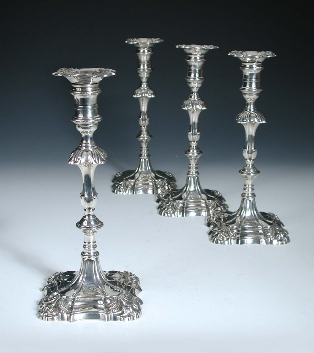 Two pairs of silver candlesticks, by Ebenezer Coker, London 1766/1767, each raised from a square