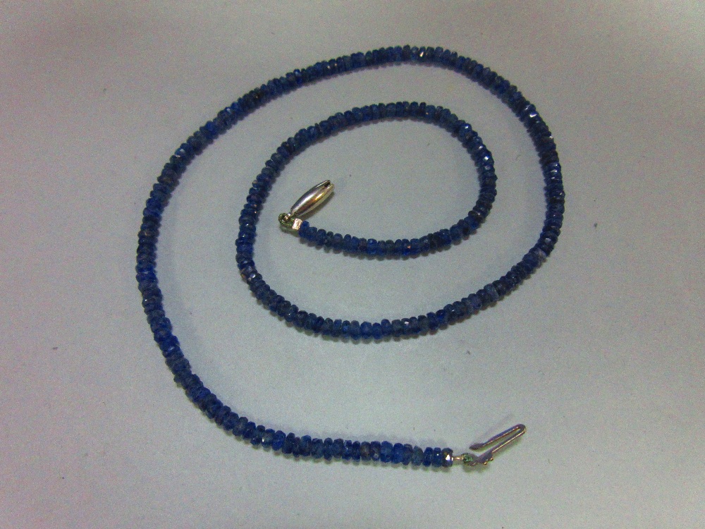 A sapphire bead necklace, the uniform 3mm diameter faceted sapphire beads of dusky mid blue, closely