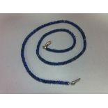 A sapphire bead necklace, the uniform 3mm diameter faceted sapphire beads of dusky mid blue, closely