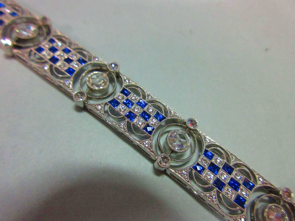 An art deco diamond and sapphire bracelet, designed as nine geometric pierced panels with a