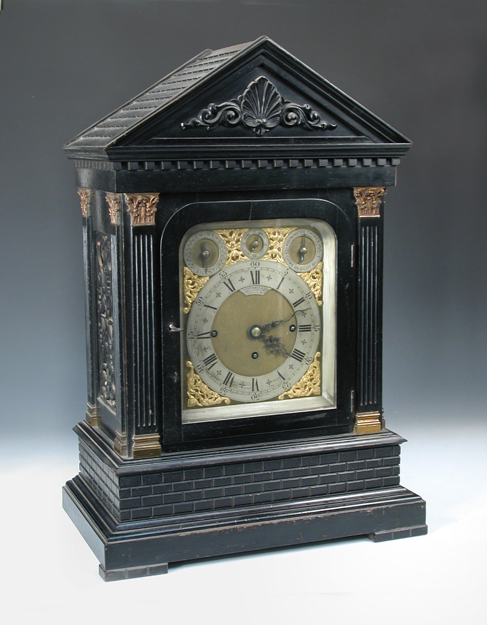 Thomas Russell & Son, London, an imposing Victorian ebonised case chiming clock, the architecturally