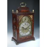 A George III mahogany bracket clock, the bell top case with brass handle and four gilt finials above