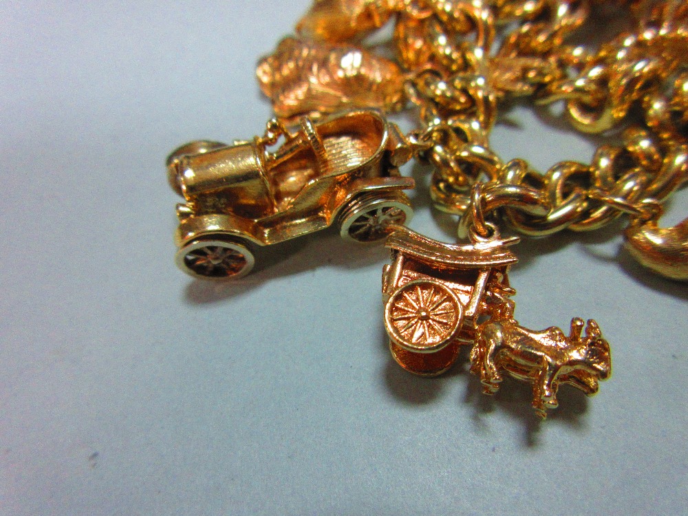 A 9ct gold charm bracelet with 17 charms, the substantial curb link bracelet, hallmarked Sheffield - Image 6 of 6