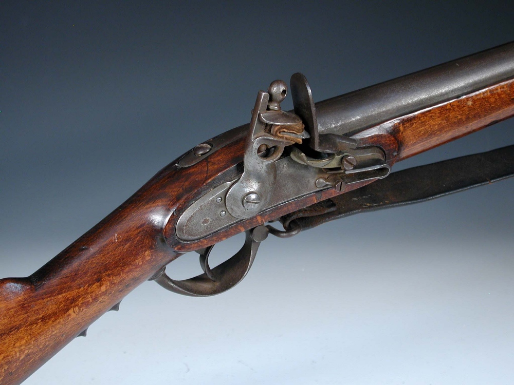 An early 19th century 'Brown Bess' type flintlock musket, the steel barrel with bayonet socket and