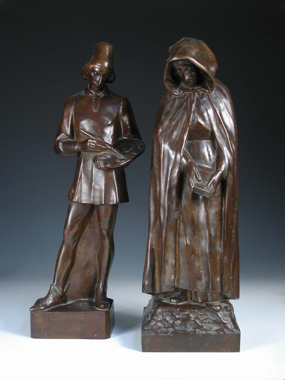 Karel Laloo (1883-1957), a bronze figure of a lady, she stands wearing a hooded cloak, she looks