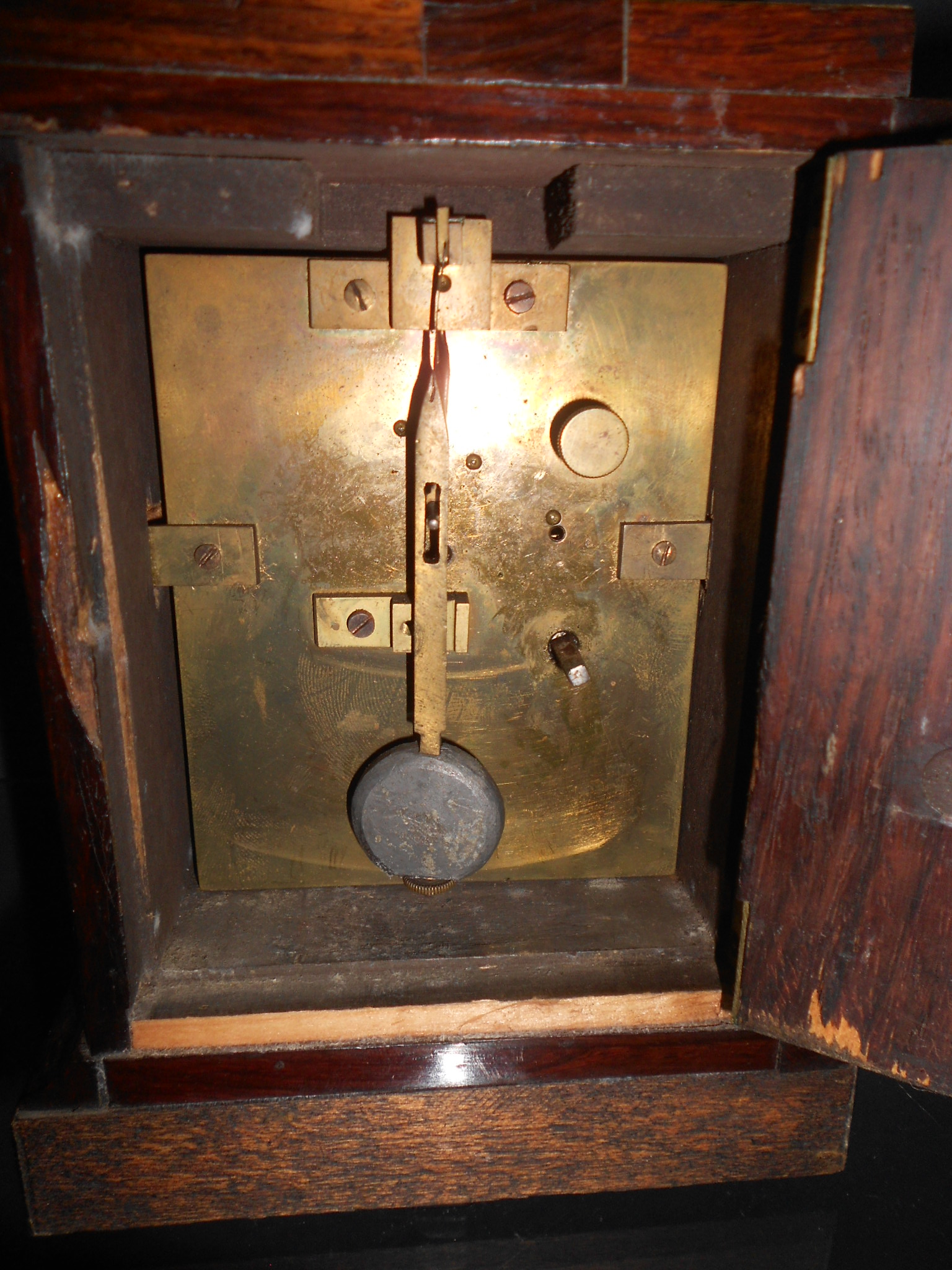 A small late Victorian rosewood mantel timepiece, the engraved rectangular gilt mask signed 'James