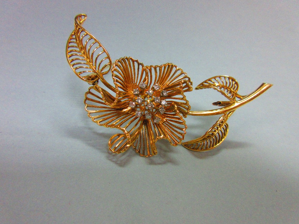 A mid-20th century diamond set flower brooch, of open wirework structure with three curled leaves