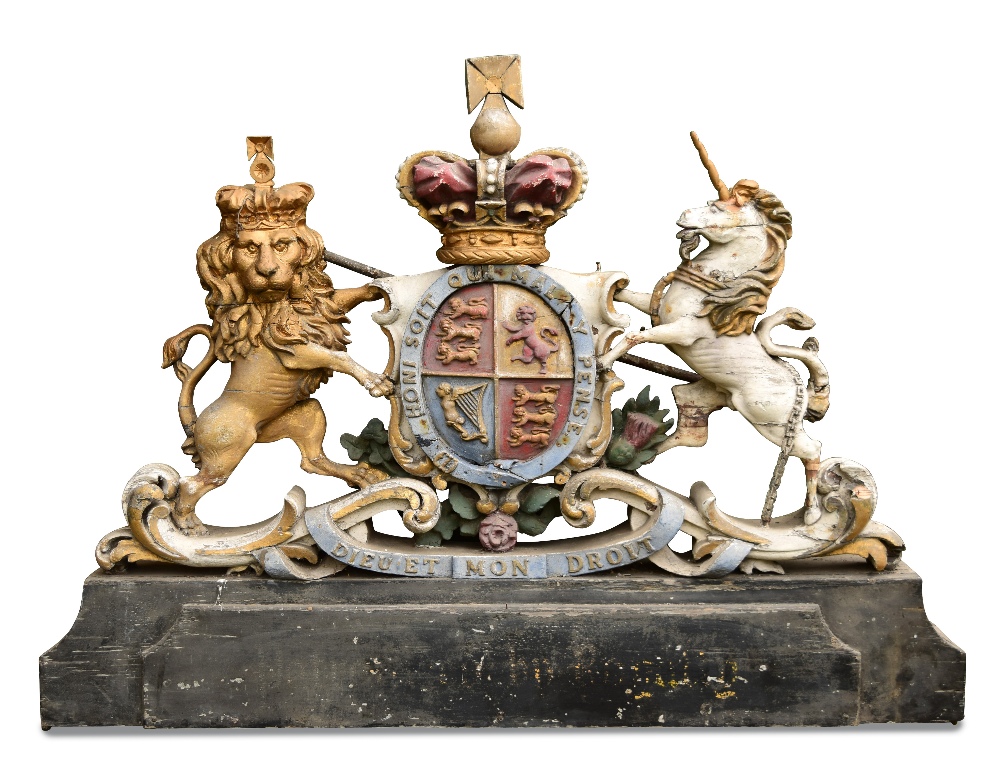 A late 19th/early 20th century polychrome wood Royal Arms, crown crested above the motto belted