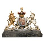 A late 19th/early 20th century polychrome wood Royal Arms, crown crested above the motto belted