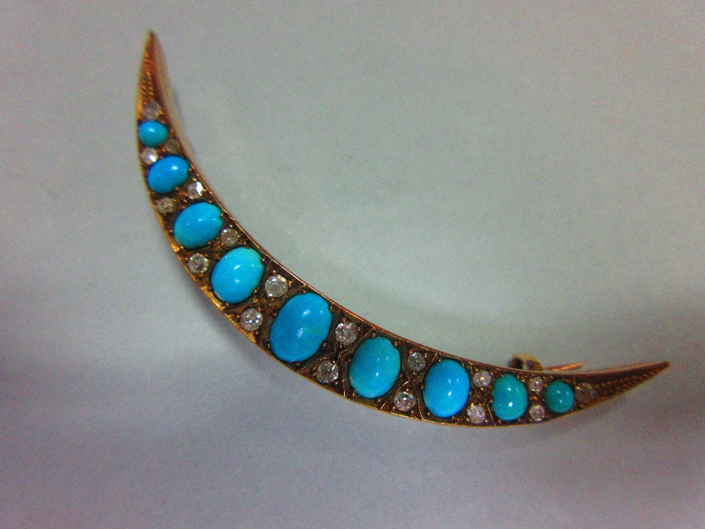 A turquoise and diamond crescent brooch, the open crescent set with graduated oval cabochon