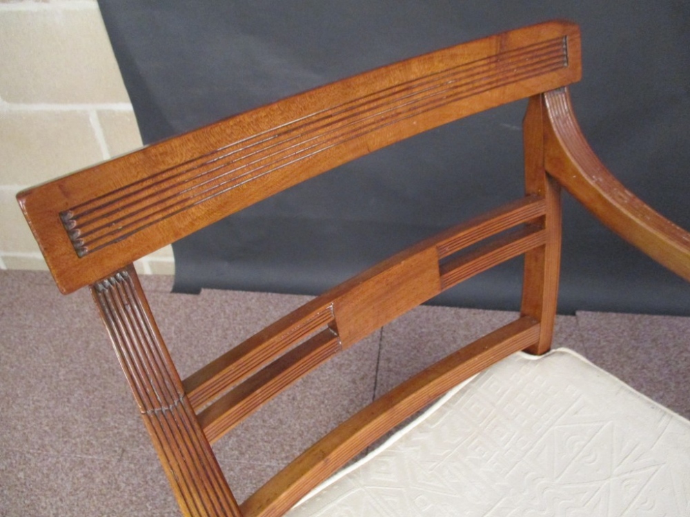 A pair of Regency fruitwood elbow dining chairs, with reeded bar backs and dished panel seats, - Image 2 of 3