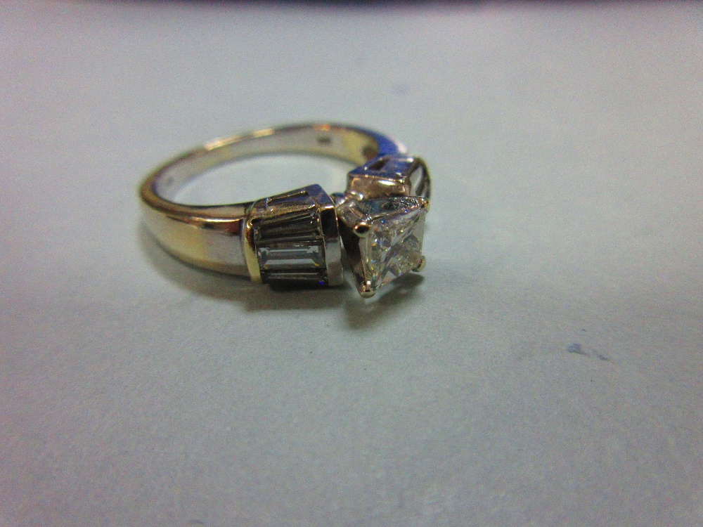 A contemporary princess cut diamond ring, the principal diamond four claw set to flying shoulders - Image 2 of 6