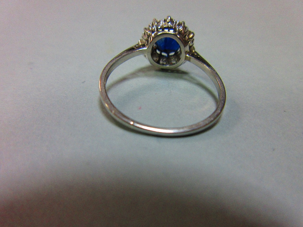 A sapphire and diamond cluster ring, the round cut sapphire in a border of old variously round cut - Image 4 of 5