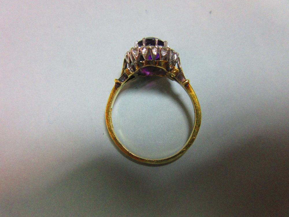 An amethyst and diamond cluster ring, the oval mixed cut rich purple amethyst claw set in a border - Image 5 of 8