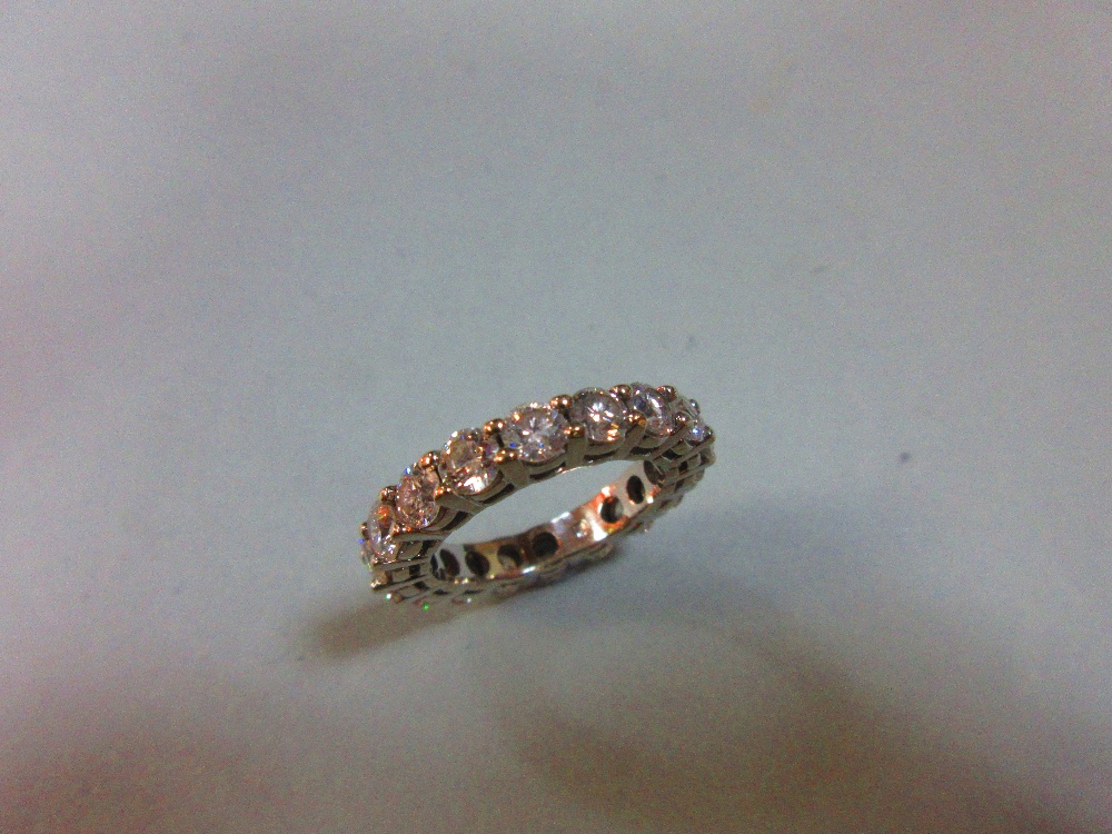 A diamond full hoop eternity ring, set with eighteen round brilliant cut diamonds in white