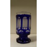 A mid 19th century Bohemian blue overlay tumbler, seven of the eight oval windows to the cylindrical