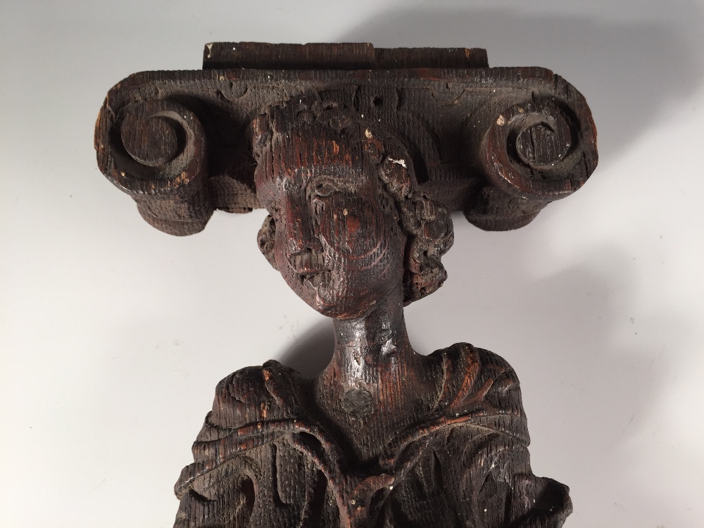 A 17th century oak term, carved as a lady in classical dress supporting an Ionic capital on her head - Image 2 of 3