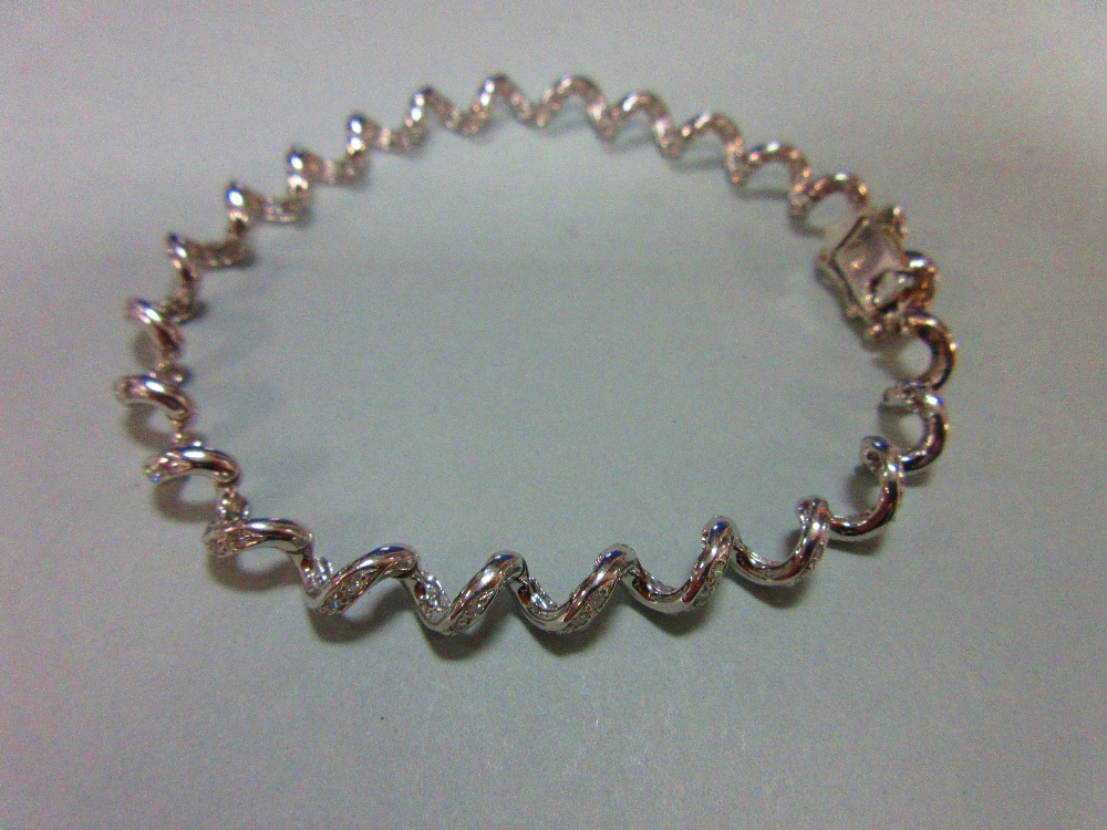 A spiral link diamond bracelet, the continuous smooth line of links forming an open centre - Image 3 of 4