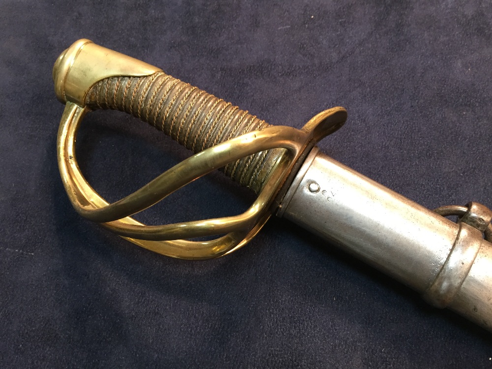 A 19th century French cavalry sword, the blade dated 1877, with brass three loop guard and wire
