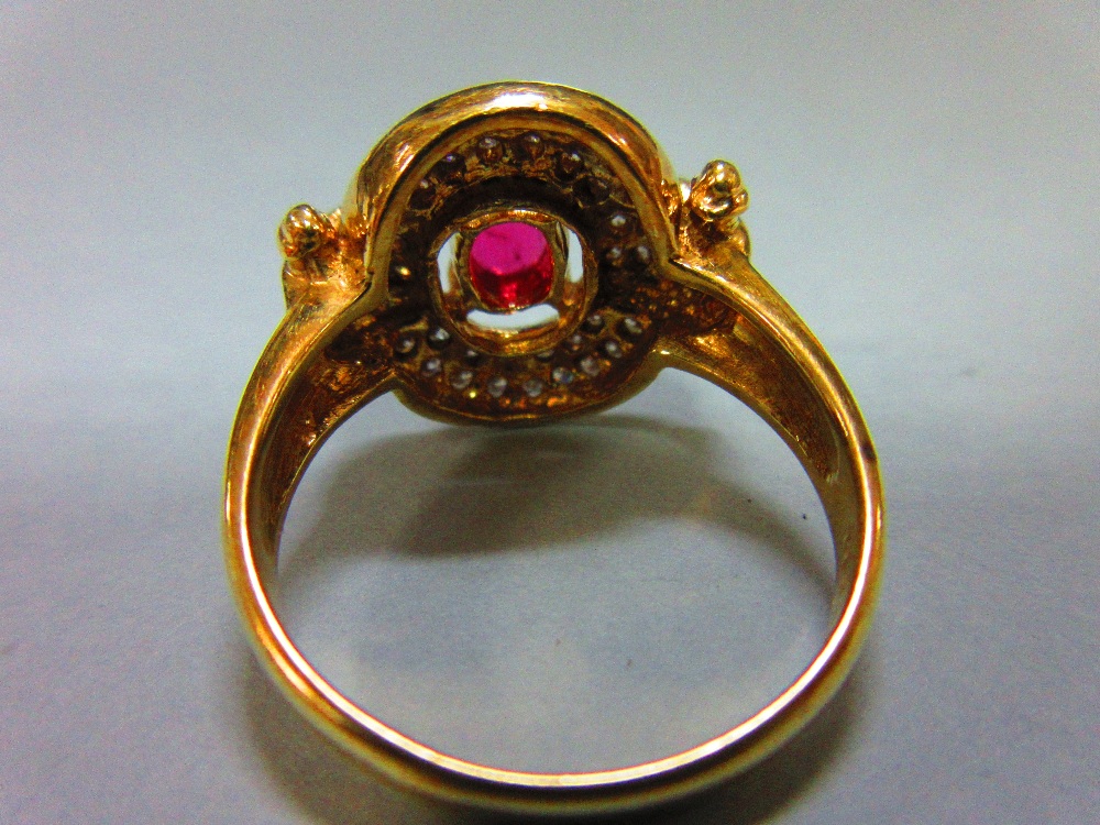 A red hardstone and diamond cluster ring, the oval cut red stone, believed to be a ruby, but not - Image 5 of 5