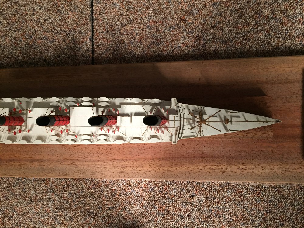 A mid 20th century painted wood model of a four-funnel passenger ship, mounted within a glazed - Image 3 of 4