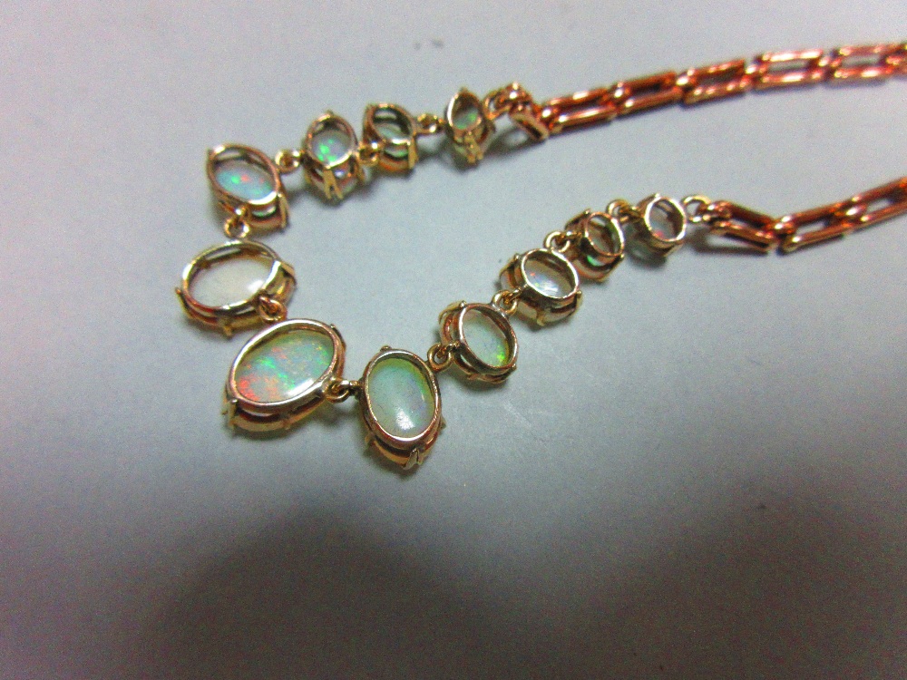 A graduated opal necklace, set to the front with an articulated line of eleven oval cabochon opals - Image 6 of 6