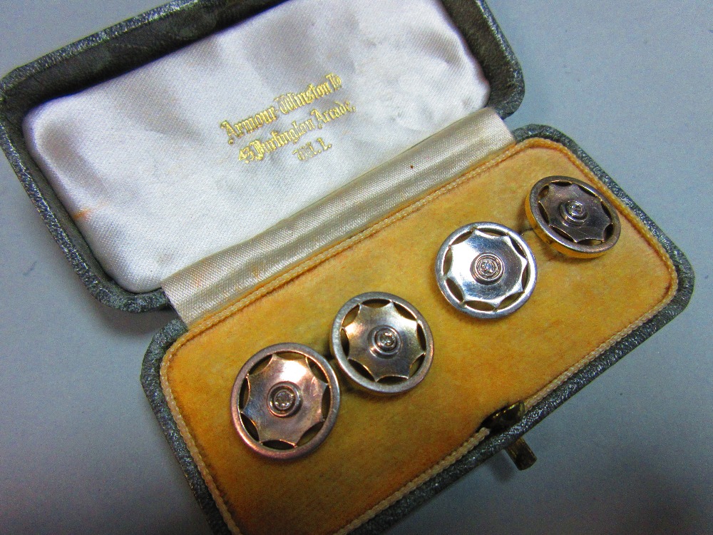A pair of diamond set double ended cufflinks, each 1.5cm diameter end designed as a stylised wheel