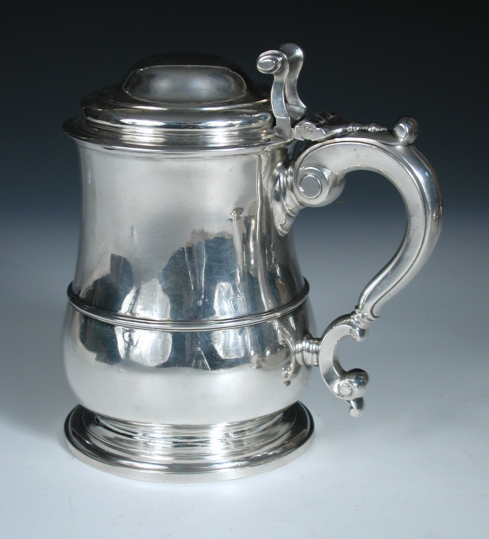 A George II silver tankard, by Lewis Hamon, London 1737, of plain baluster form with moulded edge