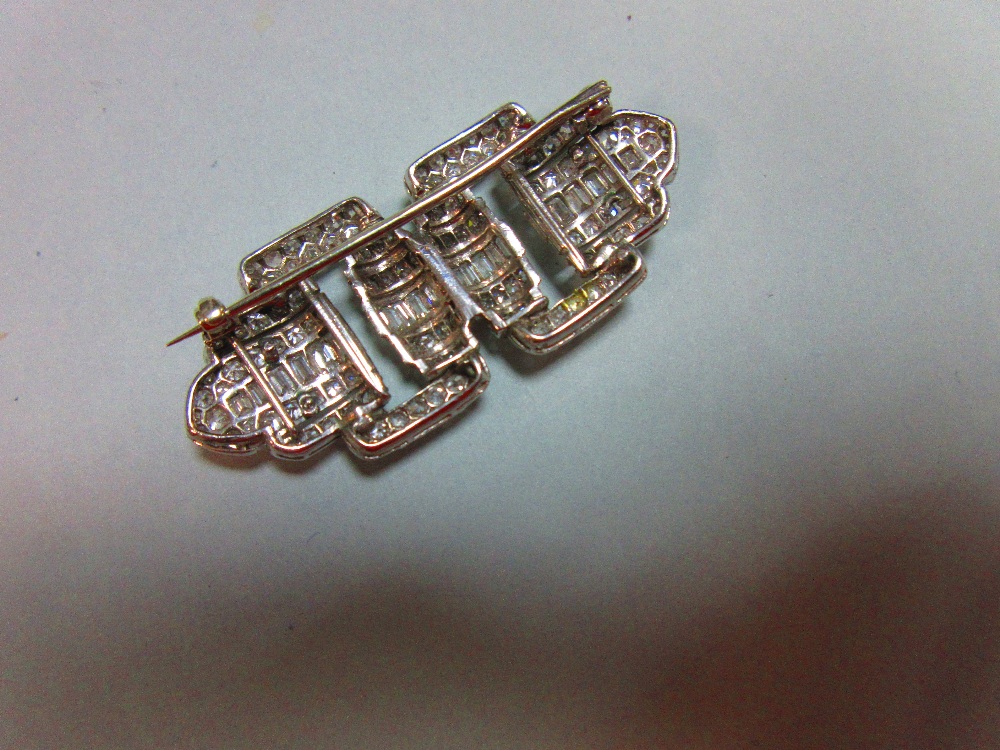 A French art deco odeonesque diamond and platinum brooch, of pierced double buckle form, with a - Image 3 of 6