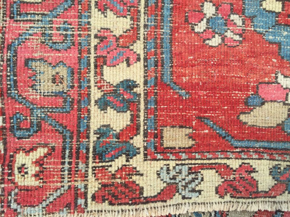 A large Heriz wool carpet, 734 x 485cm (286 x 189in) Worn and holed with end border losses, but well - Image 8 of 10