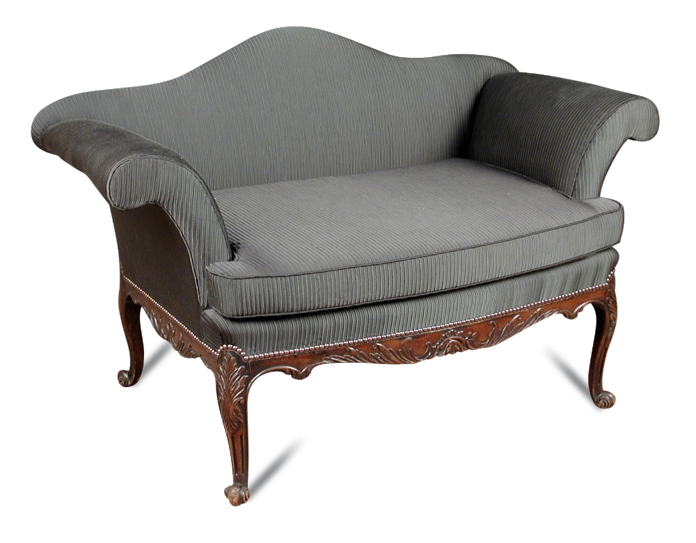 A small George III style mahogany sofa, with camel back and outscrolling arms, carved show wood,