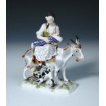 After Eberlein, a Meissen figure of the Tailor's wife, she suckles her child while riding a goat