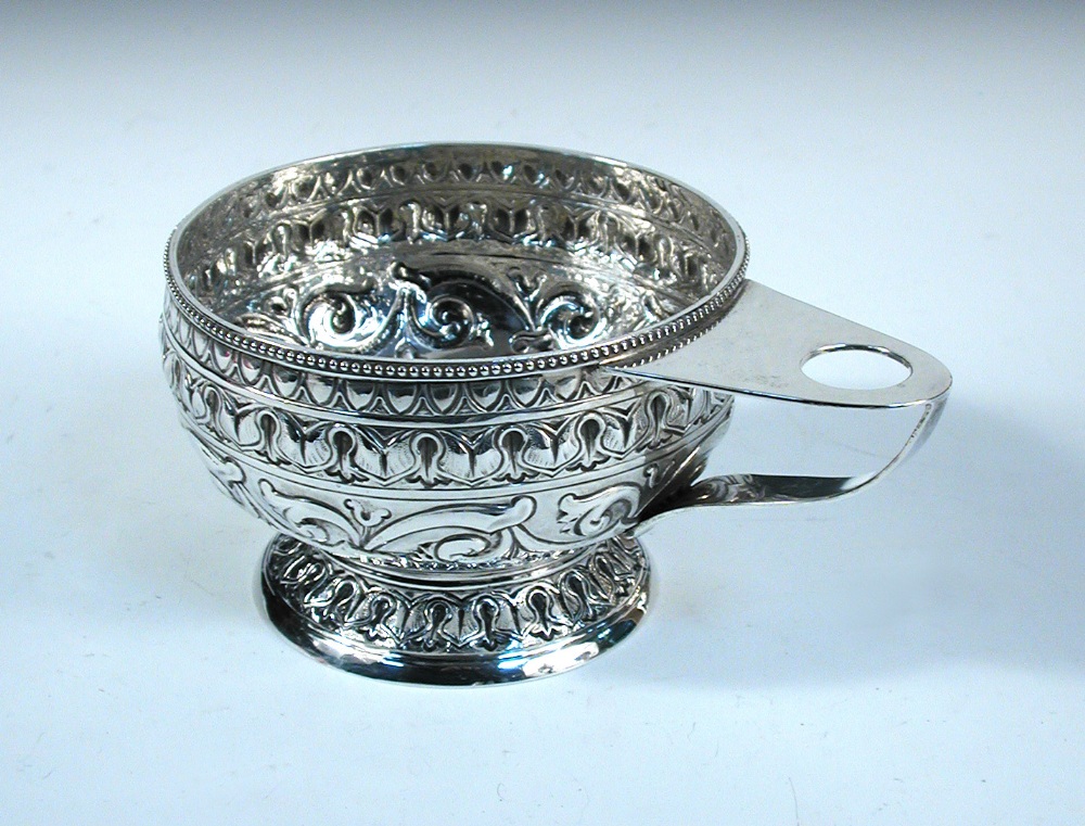 A small Arts and Crafts bowl by Nathan & Hayes, Chester 1911, circular and embossed with bands of