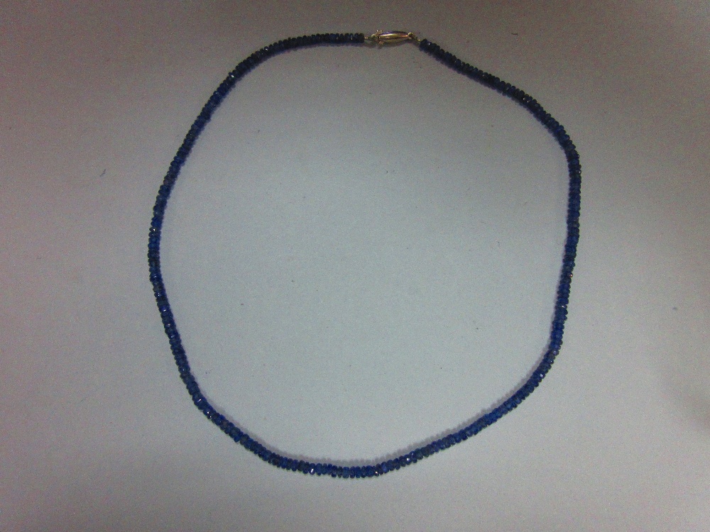 A sapphire bead necklace, the uniform 3mm diameter faceted sapphire beads of dusky mid blue, closely - Image 3 of 3