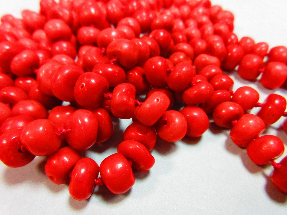 A long red coral bead necklace, the individually-knotted tyre shaped coral beads of approximately - Image 3 of 5
