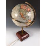 A Geographia 10 inch electric terrestrial globe, on a lacquered brass support and moulded wooden